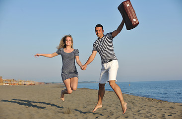 Image showing couple on beach with travel bag