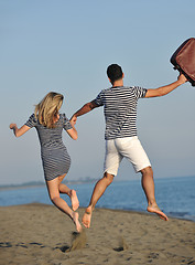 Image showing couple on beach with travel bag