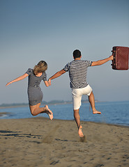 Image showing couple on beach with travel bag