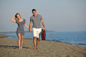 Image showing couple on beach with travel bag