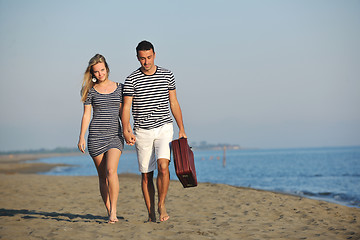 Image showing couple on beach with travel bag