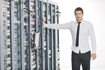 Image showing young it engeneer in datacenter server room