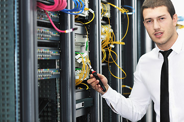 Image showing young it engeneer in datacenter server room