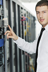 Image showing young it engeneer in datacenter server room