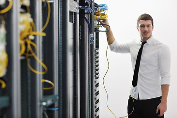 Image showing young it engeneer in datacenter server room