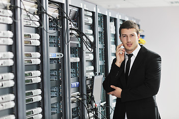 Image showing young it engeneer in datacenter server room