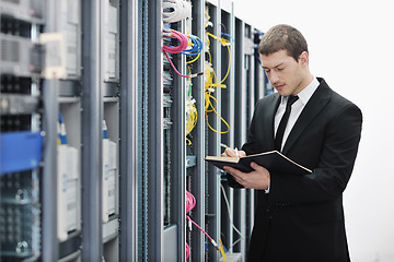 Image showing it businessman withnotebook in network server room