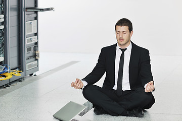 Image showing business man practice yoga at network server room