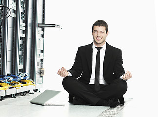 Image showing business man practice yoga at network server room