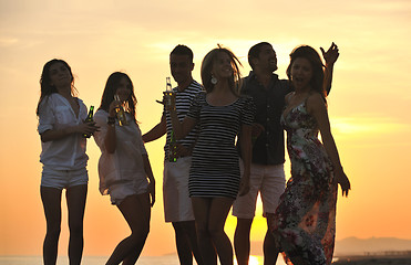 Image showing Group of young people enjoy summer  party at the beach