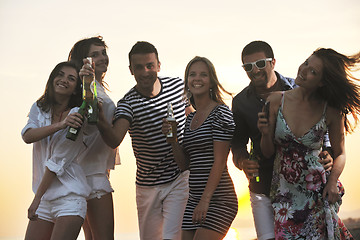 Image showing Group of young people enjoy summer  party at the beach