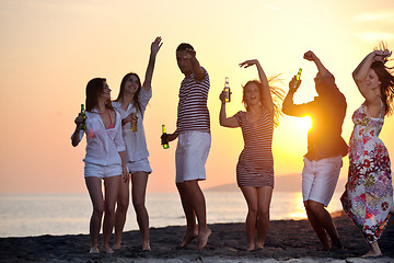 Image showing Group of young people enjoy summer  party at the beach