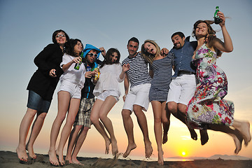 Image showing Group of young people enjoy summer  party at the beach
