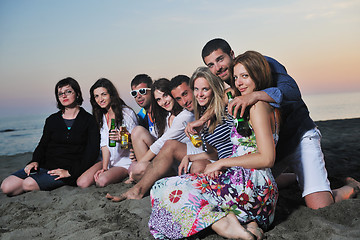 Image showing Group of young people enjoy summer  party at the beach