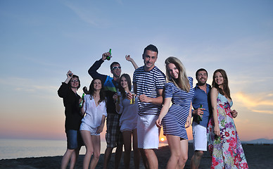 Image showing Group of young people enjoy summer  party at the beach