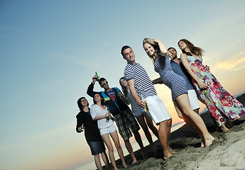 Image showing Group of young people enjoy summer  party at the beach