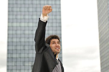 Image showing Outdoor portrait of young and happy  businessman
