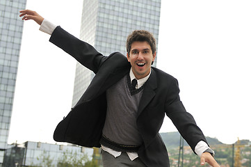 Image showing Outdoor portrait of young and happy  businessman