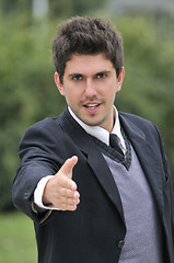 Image showing Young caucasian business man in a suite, pointing at camera to y