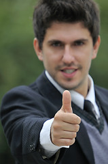 Image showing Young caucasian business man in a suite, pointing at camera to y