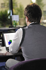 Image showing Happy man sitting and working on laptop