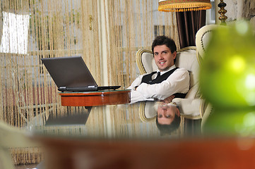 Image showing young adult working on laptop