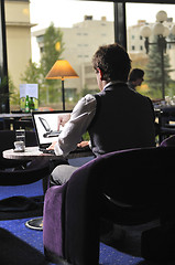 Image showing Happy man sitting and working on laptop