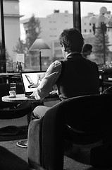 Image showing Happy man sitting and working on laptop