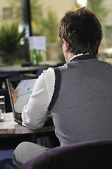 Image showing Happy man sitting and working on laptop