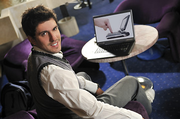 Image showing Happy man sitting and working on laptop