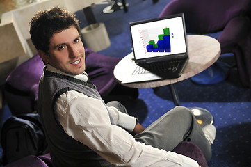 Image showing Happy man sitting and working on laptop