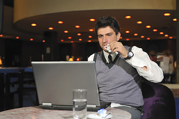 Image showing Buisinessman drinking coffe while working