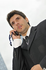 Image showing Photo of happy winner businessman  talking on mobile phone