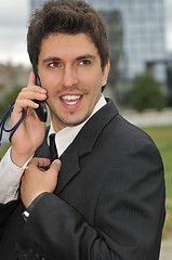 Image showing Photo of happy winner businessman  talking on mobile phone