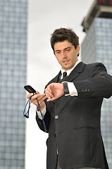 Image showing Photo of happy winner businessman  talking on mobile phone