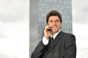Image showing Photo of happy winner businessman  talking on mobile phone
