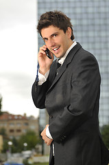 Image showing Photo of happy winner businessman  talking on mobile phone