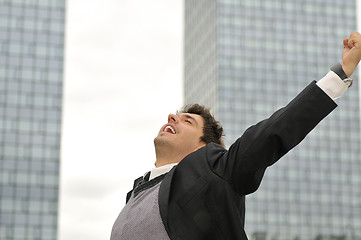 Image showing Outdoor portrait of young and happy  businessman