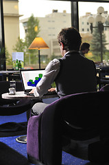 Image showing Happy man sitting and working on laptop