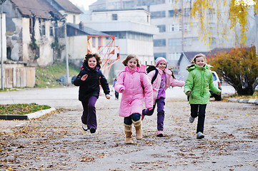 Image showing school girls running away 