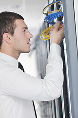 Image showing young engeneer in datacenter server room