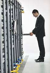 Image showing young engeneer in datacenter server room