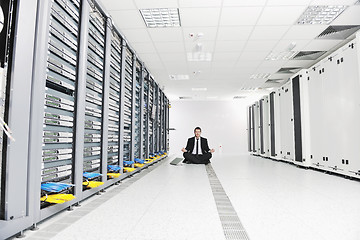 Image showing business man practice yoga at network server room