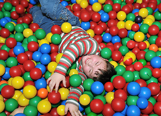 Image showing happy child in colorful balls 