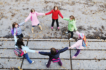 Image showing school girls running away