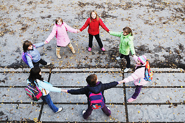 Image showing school girls running away