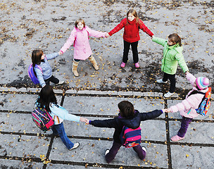 Image showing school girls running away