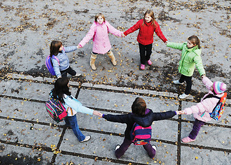 Image showing school girls running away