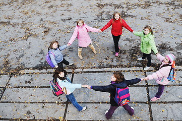 Image showing school girls running away