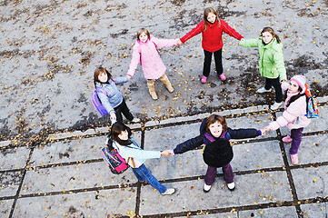 Image showing school girls running away